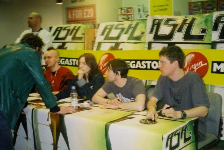 people sitting at a table talking to one another