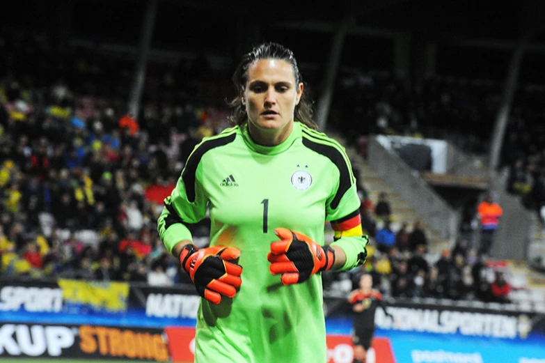 a soccer player standing in front of the crowd