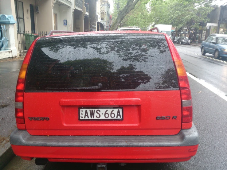 a red vehicle parked on the side of a street