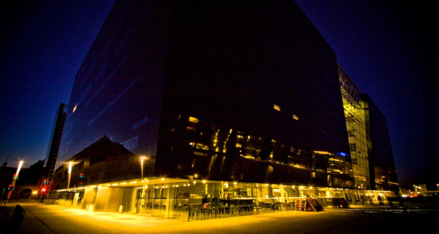 the reflection of a city building on the glass walls