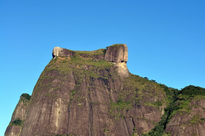 the mountains surrounding this area have grass growing on them