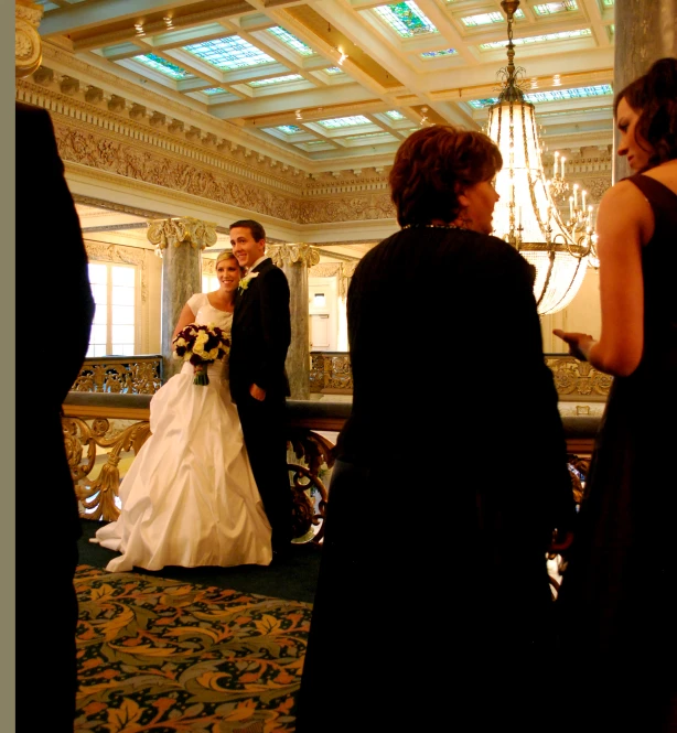 a bride and groom posing together for a po in a el room