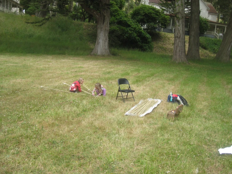 three children are playing with an electric trampoline