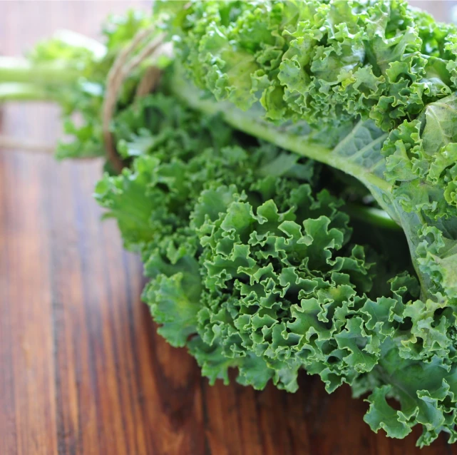 an assortment of green vegetables sitting on a table