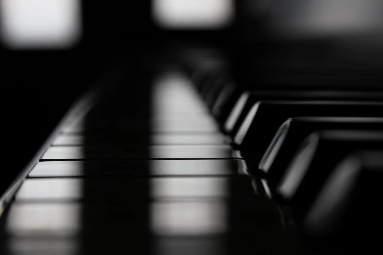 an upright black piano with some white squares