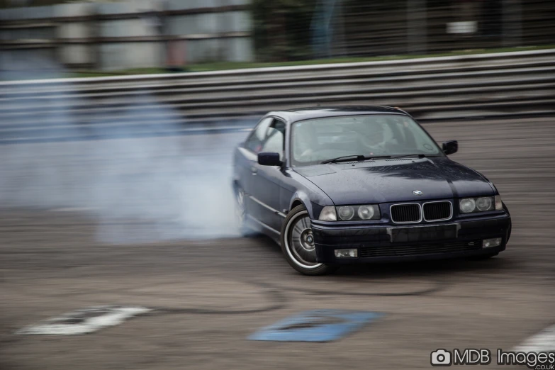 a smoke machine blowing off the hood of a black car