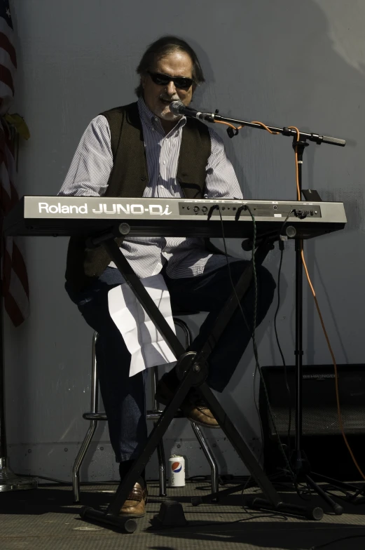 a man that is sitting under a musical instrument