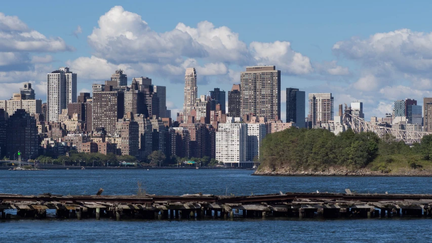 a harbor and skyline view with people fishing on the water