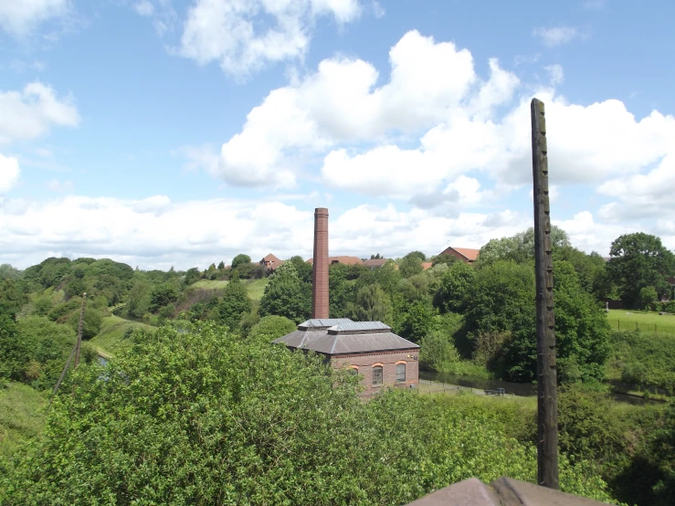 a picture of a building in a field with trees