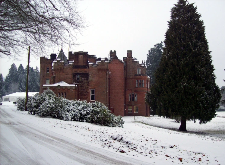 an old building that has snow on the ground