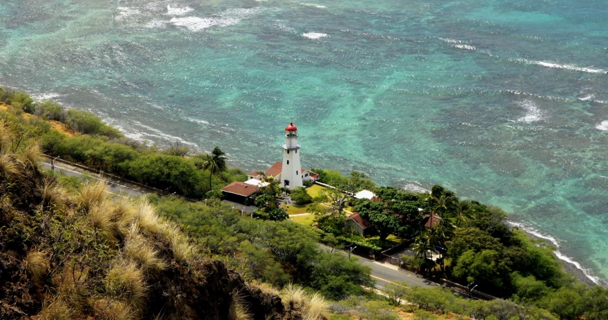 an aerial view of a lighthouse near a water area