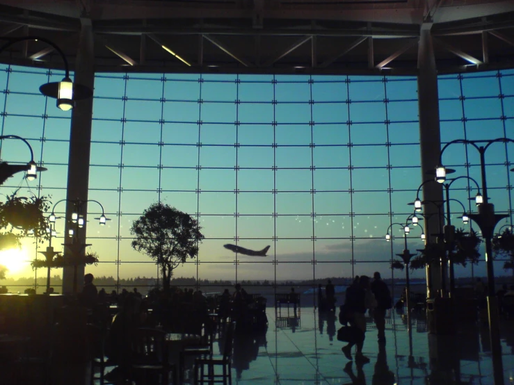 an airport terminal with some people walking around