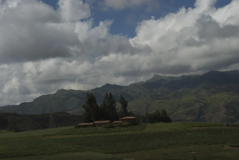 clouds fill the sky above some houses