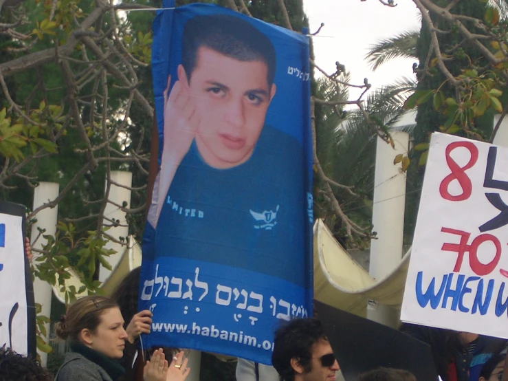 some people holding signs and posters