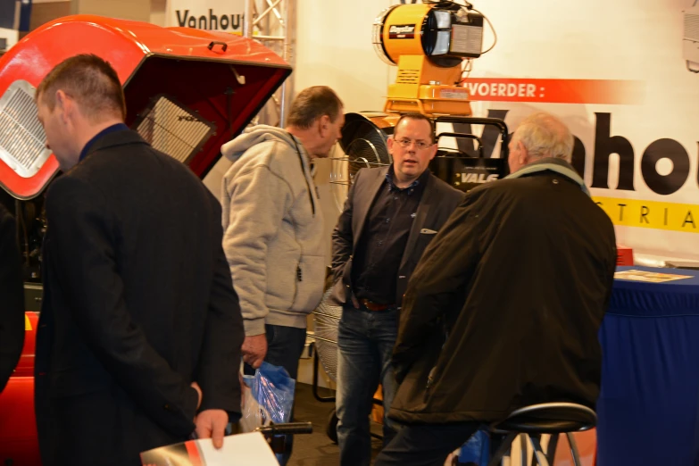 men standing around in an indoor show room