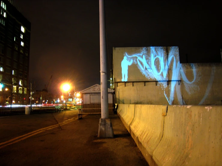 a wall and lights in a city at night