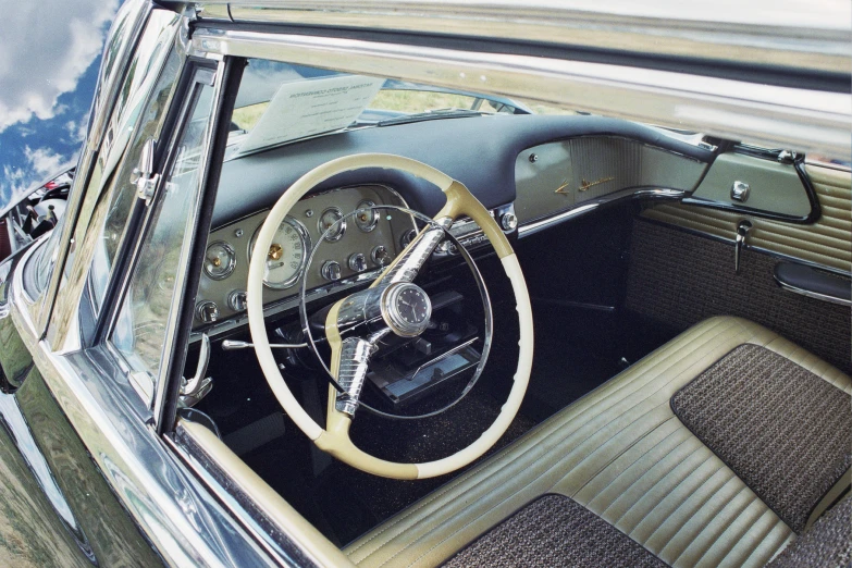 the interior of a old fashioned car with a steering wheel