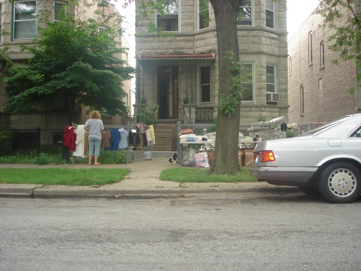 a couple stands on the side of a street by their house