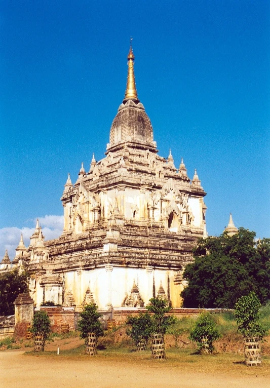 a tall white building that has gold spire