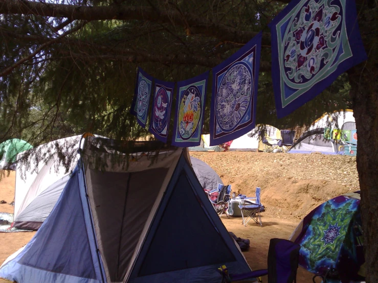 several blue and brown tents on a field