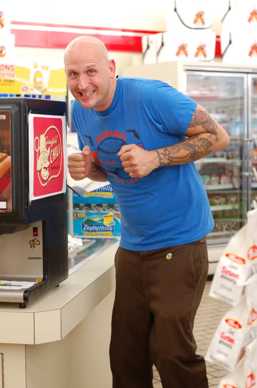 a man showing off some kind of food at a store