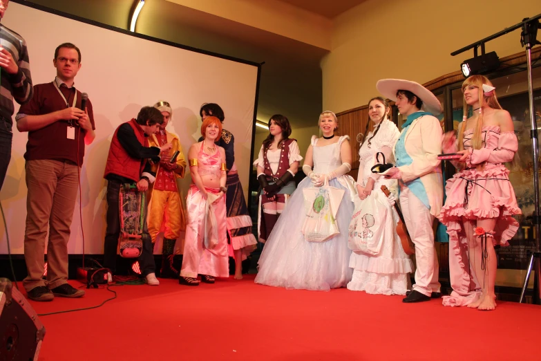 a man takes pictures of a group of young s in costumes