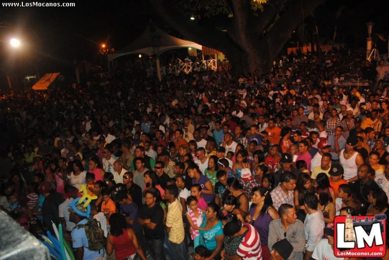 a large crowd of people outside at night