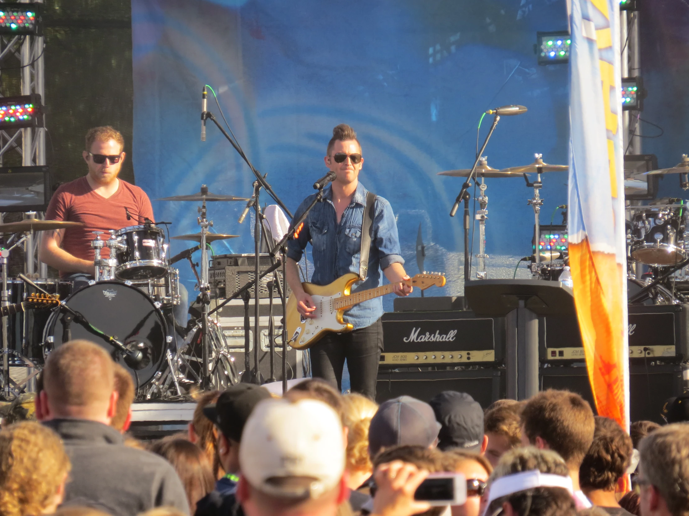 a group of people sitting in front of some stage speakers