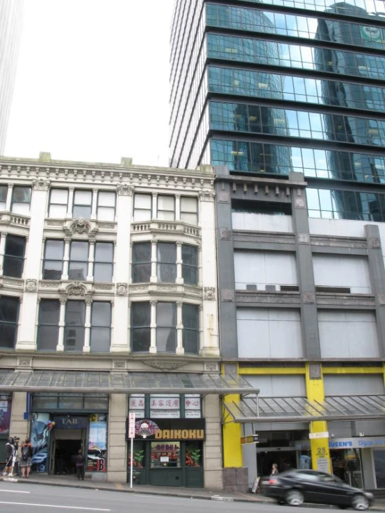 a view of buildings in front of some large tall buildings