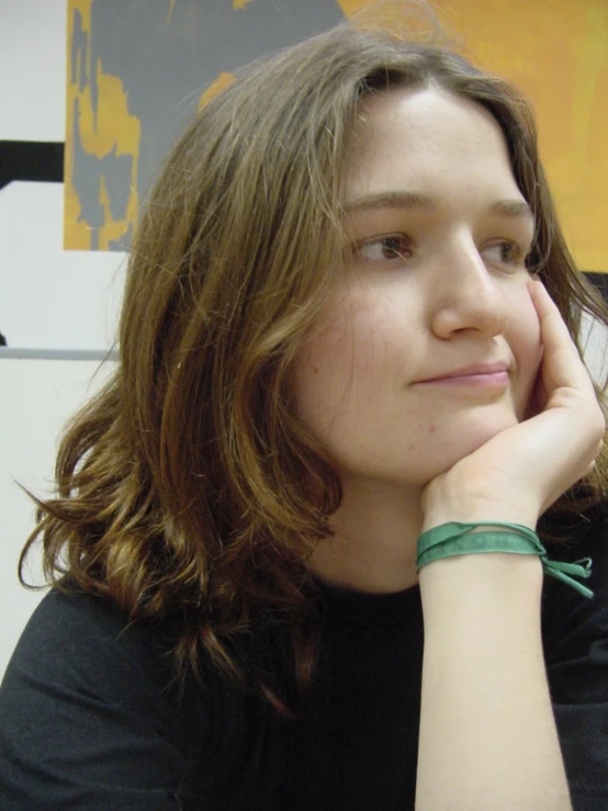 a woman is sitting and looking into the camera