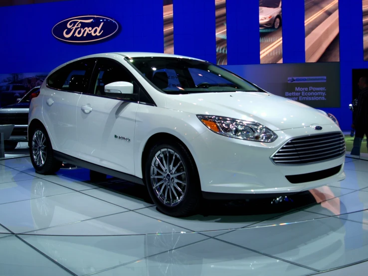 white and black ford on display at an auto show