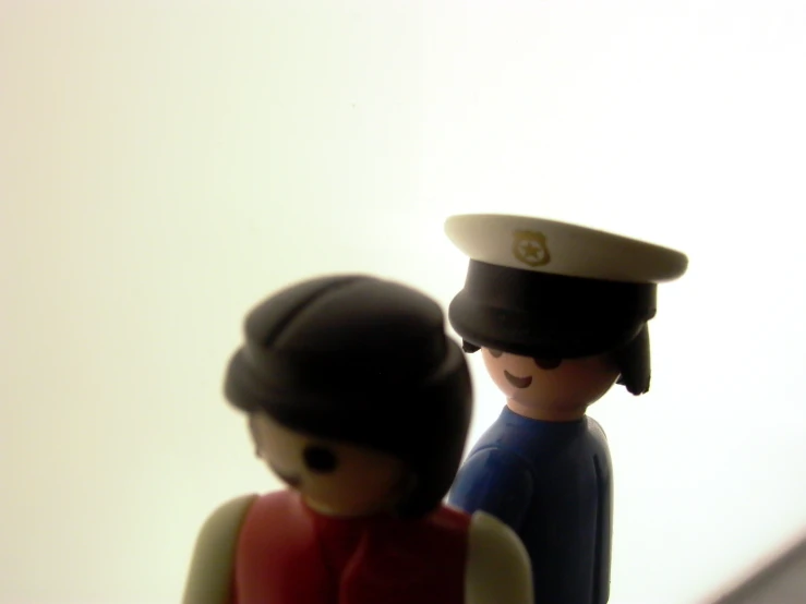a toy couple that are wearing a military uniform