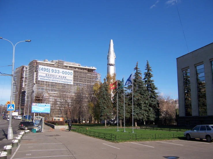 a large rocket sitting on top of a tall building