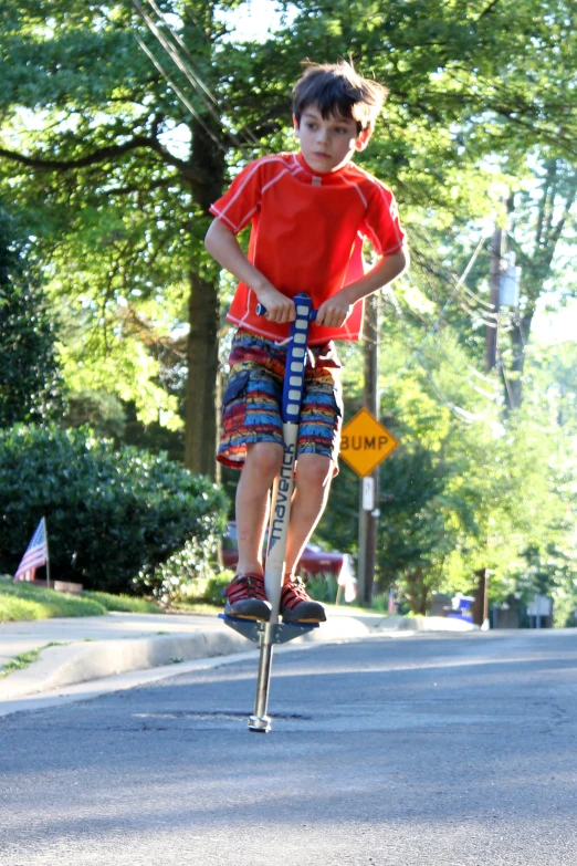 a boy riding on a small roller skate