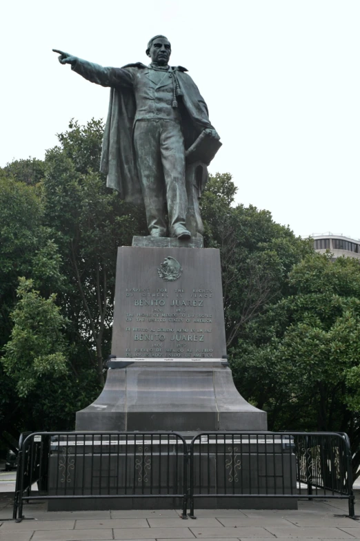 the large bronze statue has a hat on it's head