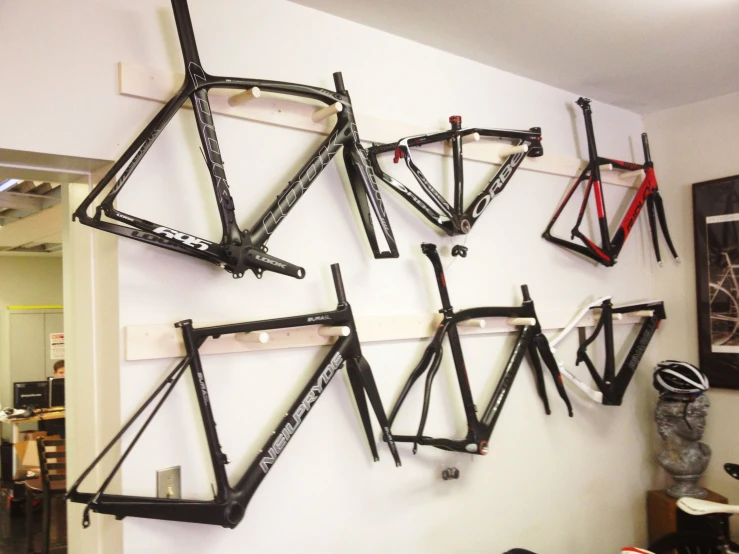 the bicycle frame is hanging on the wall