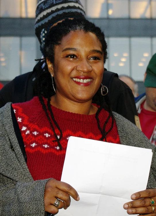 a lady holding a white piece of paper