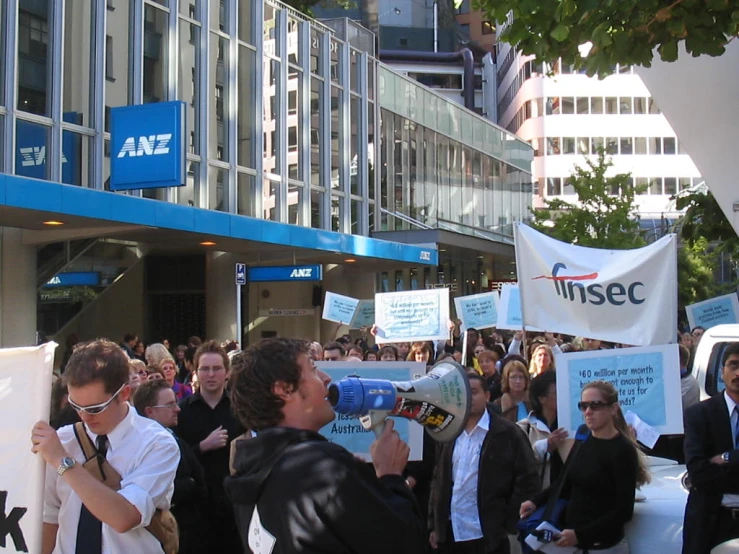 a crowd of people with protest signs outside