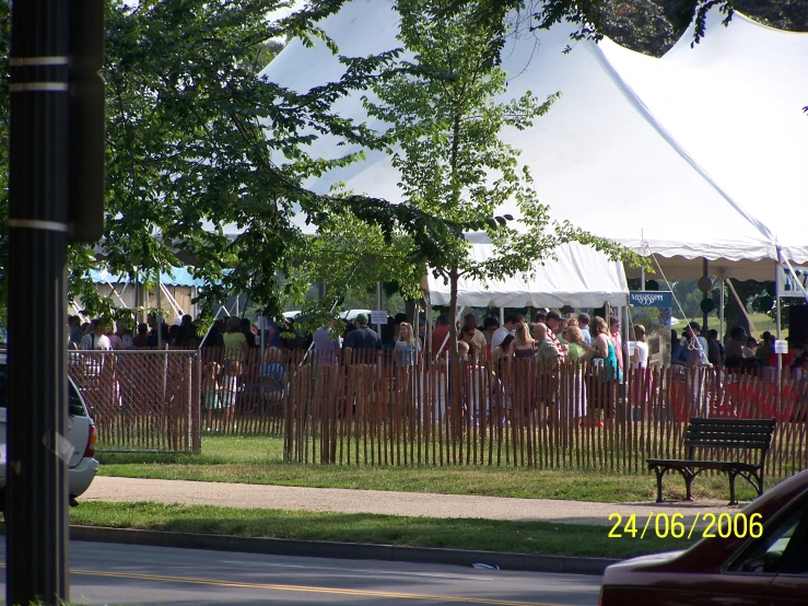 a group of people are standing on the grass