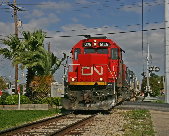 a large train on a steel track near some power lines