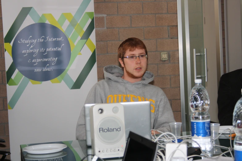 a man sitting at a table with a laptop computer