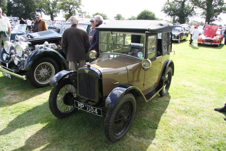 an old car on display at a vintage car show