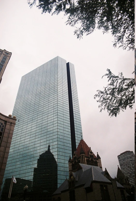 a building that is very close up and reflecting the sky