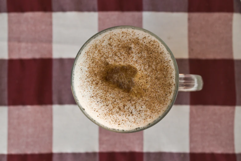 an overhead view of a beverage that is overflowing with brown and white liquid