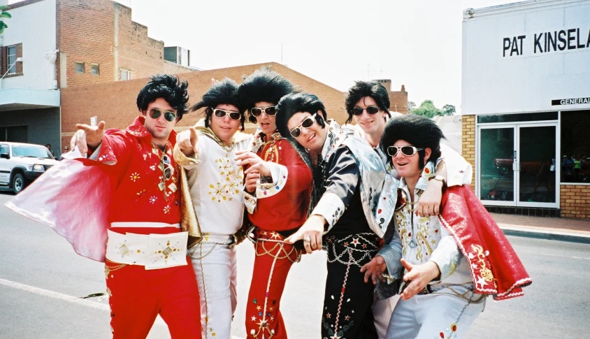 the rolling stones pose for a picture in a street