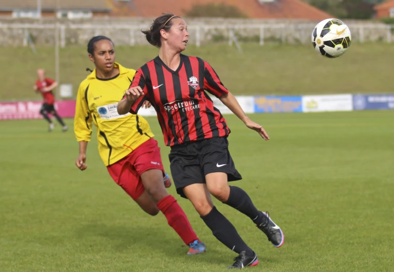 two soccer players fight for the ball in an attempt to make contact