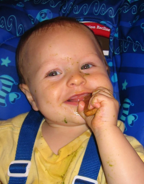 a baby is eating a piece of food