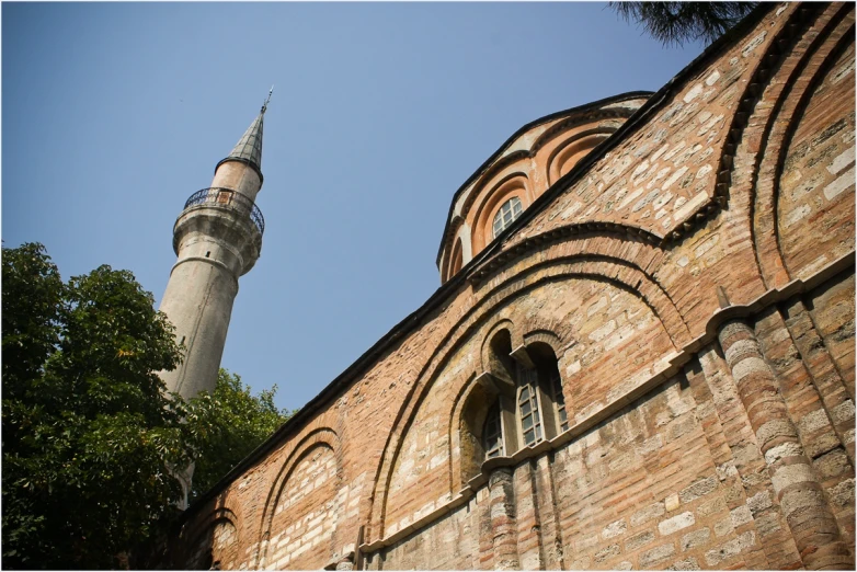 a tall brick building near a large tower