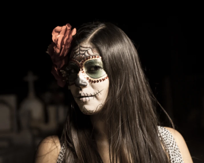 woman wearing makeup with a skull painted on her face