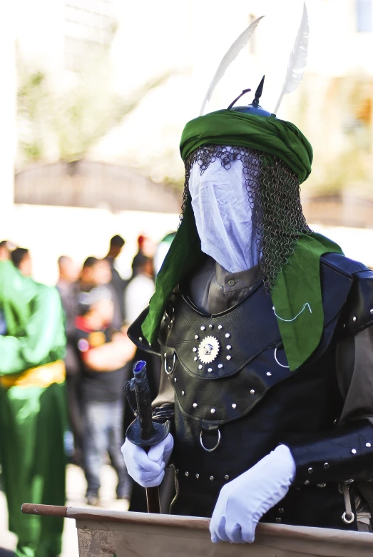 a man dressed as an knight in front of a crowd